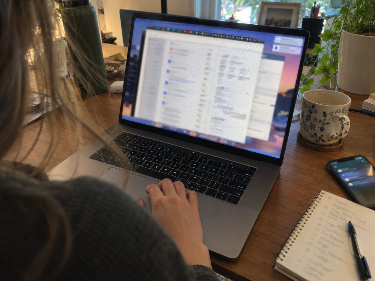 A laptop crowded with open windows and notifications